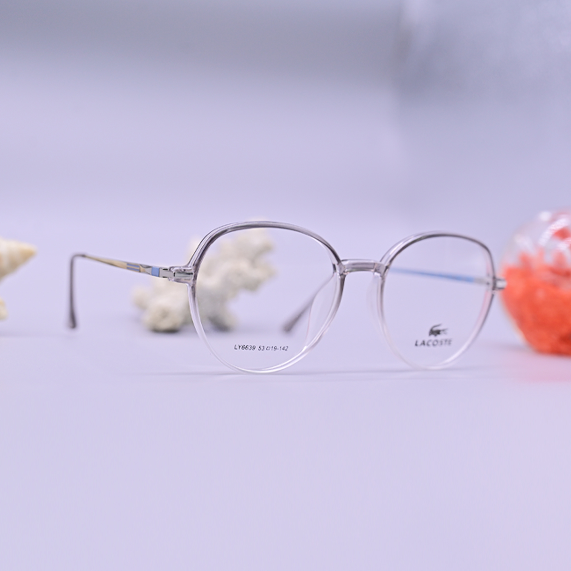 نظارة طبية من ماركة لاجوست موديل 6639، إطار دائري كامل بلون بيج (نود) شفاف مع أذرع معدنية نحيفة باللون الذهبي، متوفرة لدى عين العون.