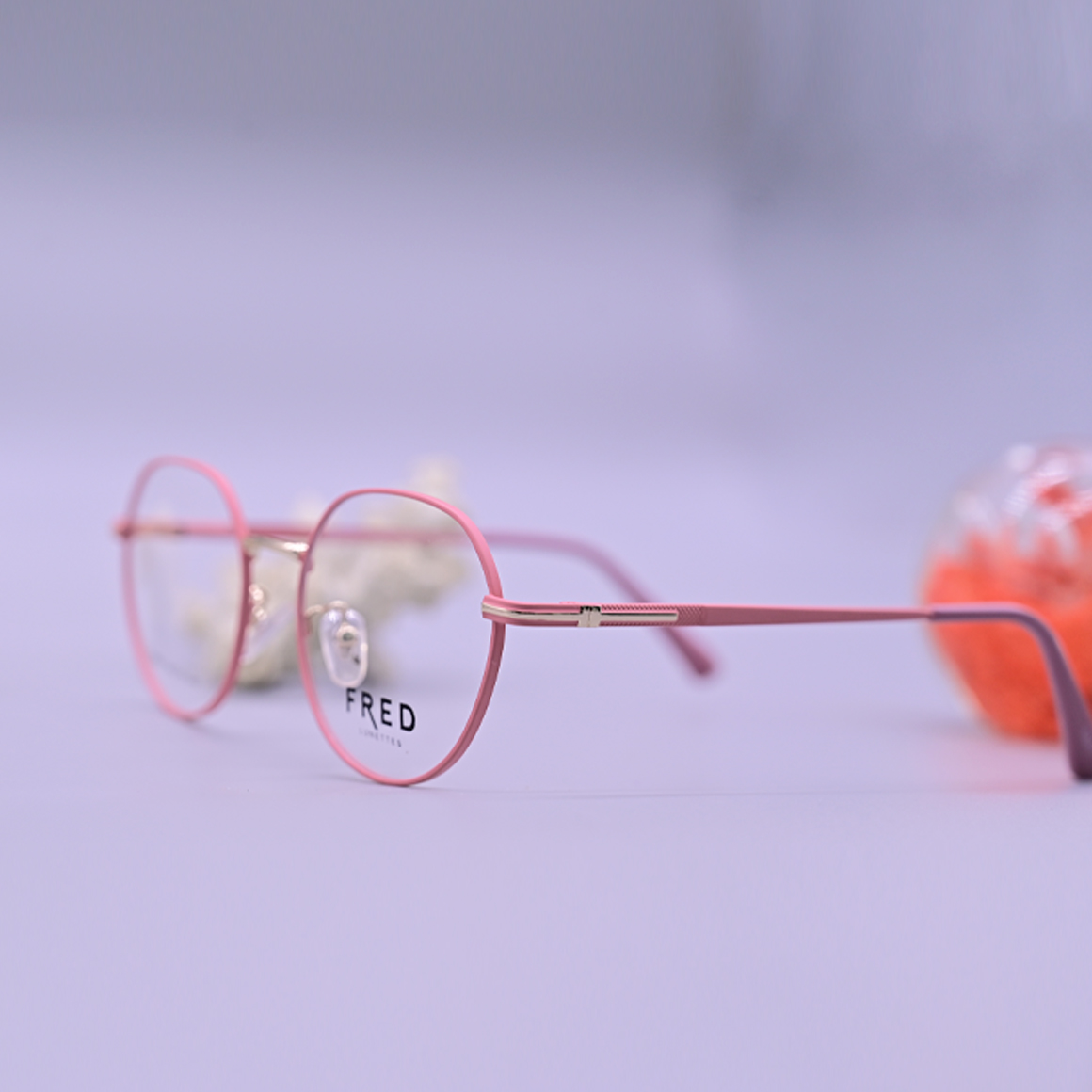 نظارة طبية ماركة فريد موديل 8891 بإطار كامل وردي نحيف وتصميم دائري هندسي مع جسر أنف ذهبي وأذرع رقيقة.