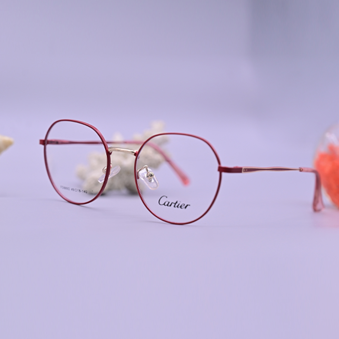 نظارة طبية ماركة كارتير موديل 8892 بإطار كامل بلون وردي داكن وتصميم دائري كلاسيكي مع جسر أنف معدني ذهبي وأذرع نحيفة أنيقة.